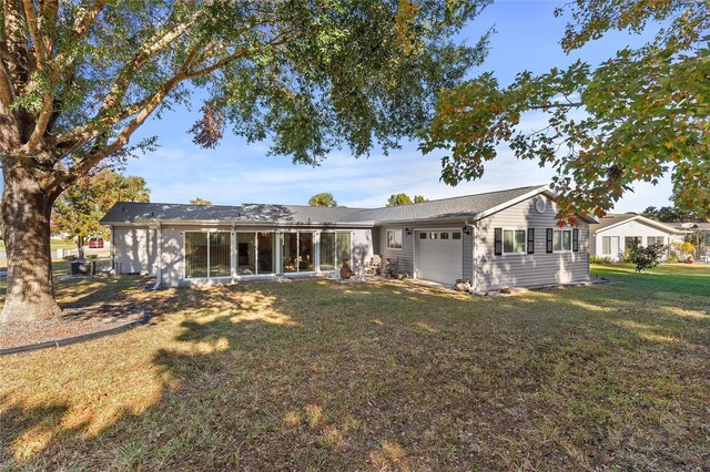 view of front facade with a garage and a front lawn