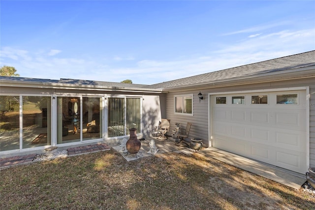 rear view of house featuring a garage