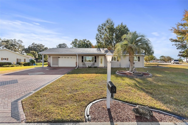 ranch-style house featuring a garage and a front lawn