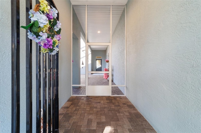 8706 SW 88th Pl, Ocala, FL 34481 - corridor with brick flooring and a textured wall