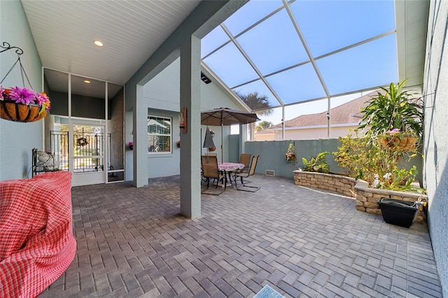 view of patio featuring a lanai