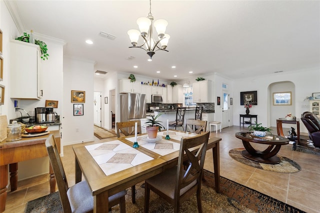 dining space featuring a chandelier and ornamental molding