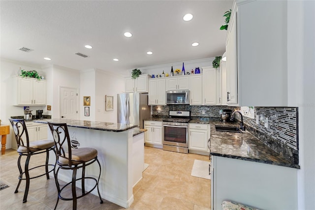 kitchen featuring white cabinetry, sink, and appliances with stainless steel finishes