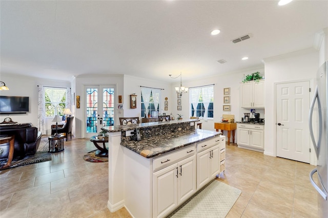 kitchen featuring pendant lighting, plenty of natural light, a center island, and french doors