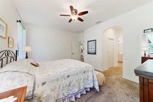 carpeted bedroom featuring ceiling fan and connected bathroom