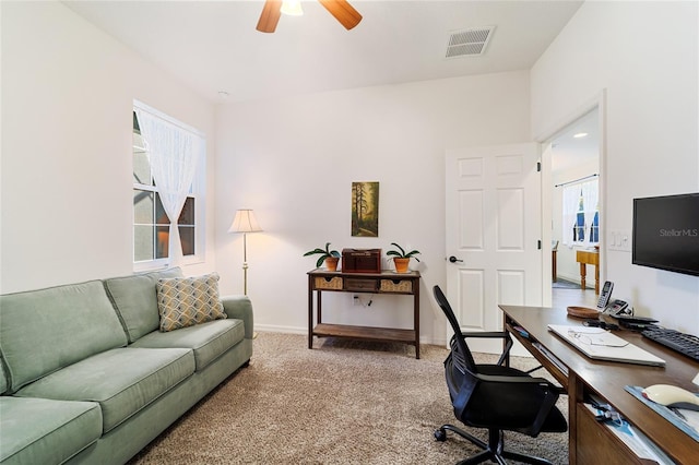 carpeted office with ceiling fan