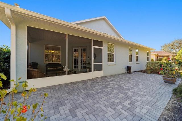 back of house with a sunroom and a patio