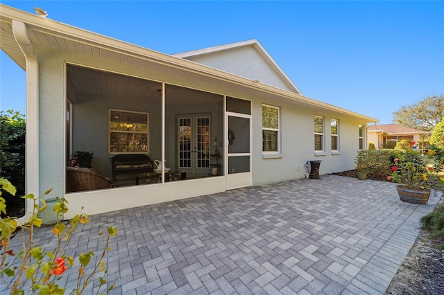 8706 SW 88th Pl, Ocala, FL 34481 - back of house with french doors, a patio, stucco siding, and a sunroom