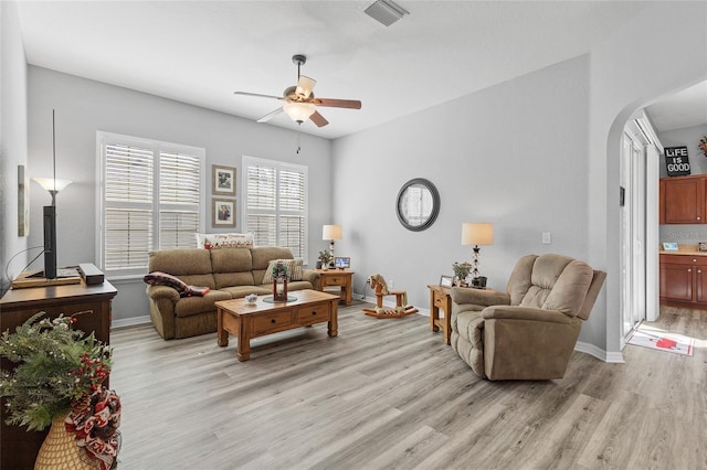 living room featuring ceiling fan and light wood-type flooring