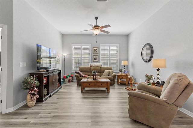 living room with ceiling fan and light wood-type flooring