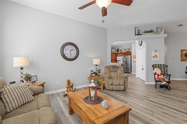 living room with ceiling fan and light wood-type flooring