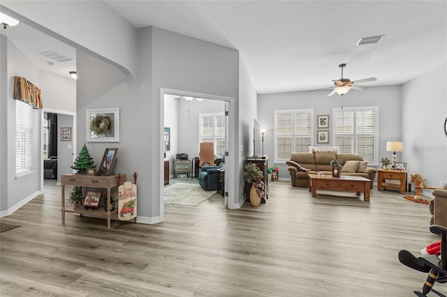 living room featuring hardwood / wood-style flooring and ceiling fan