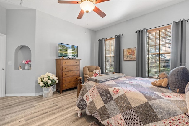 bedroom with light hardwood / wood-style floors, multiple windows, and ceiling fan