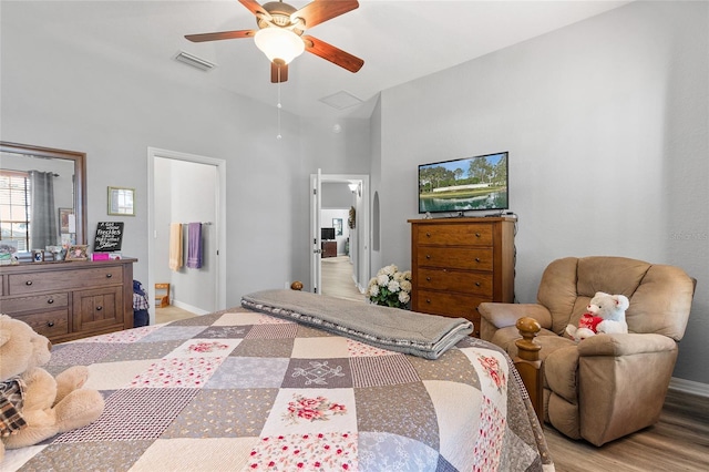 bedroom with light wood-type flooring, ensuite bath, and ceiling fan