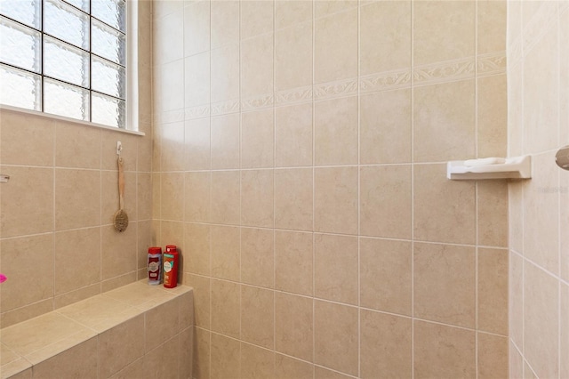 bathroom with tiled shower