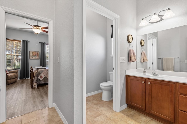 bathroom with vanity, ceiling fan, toilet, and wood-type flooring