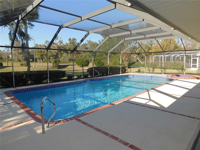 view of swimming pool with a lanai and a patio