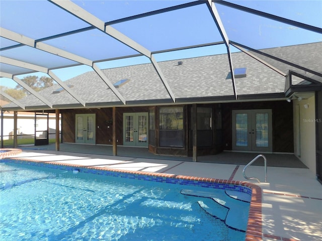 view of pool featuring french doors, a patio, and a lanai