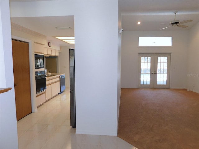 interior space featuring french doors, light colored carpet, and sink