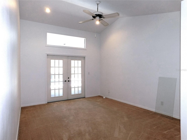 unfurnished room featuring ceiling fan, lofted ceiling, carpet floors, and french doors