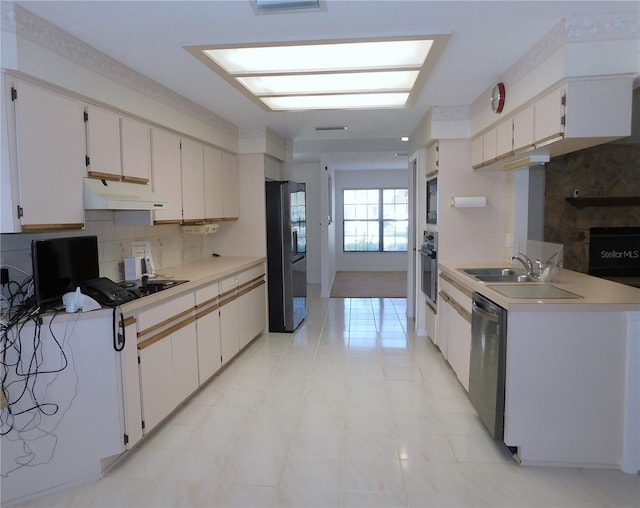 kitchen with black appliances, white cabinetry, sink, and tasteful backsplash