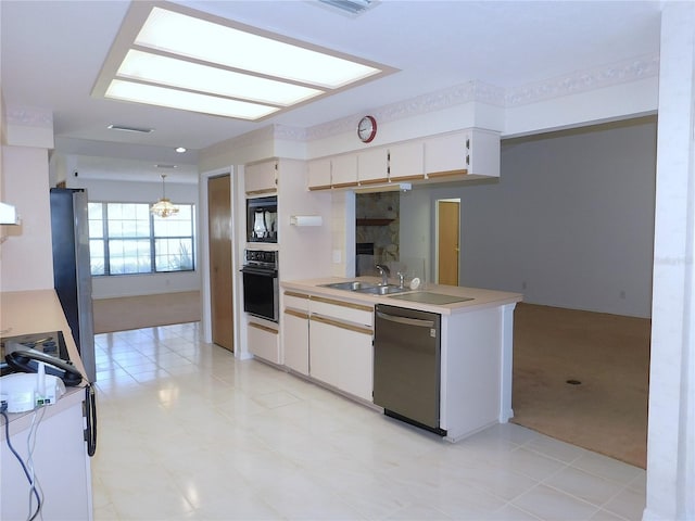 kitchen with pendant lighting, black appliances, white cabinets, sink, and light colored carpet