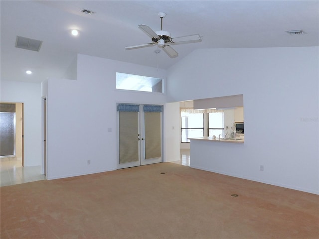 unfurnished room with ceiling fan, high vaulted ceiling, and light colored carpet