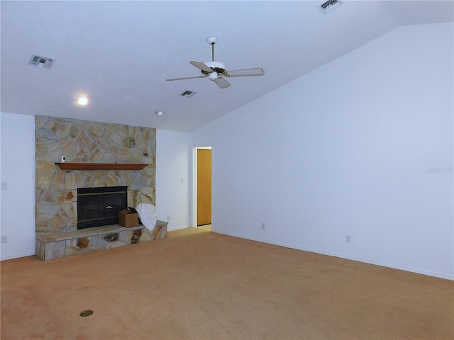 unfurnished living room with vaulted ceiling, light colored carpet, a stone fireplace, and ceiling fan