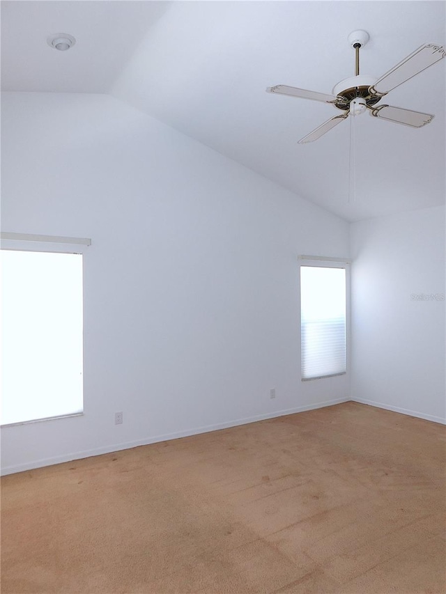 unfurnished room with ceiling fan, light carpet, and vaulted ceiling