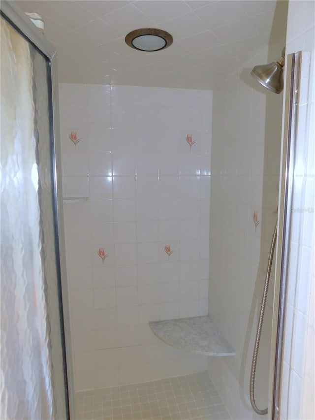 bathroom with tiled shower