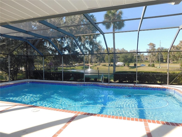 view of pool with a lanai and a water view