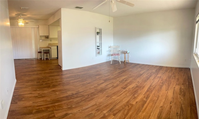 empty room with ceiling fan and dark wood-type flooring