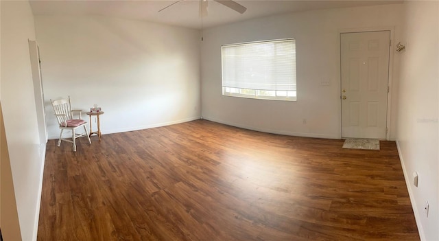 unfurnished room featuring ceiling fan and dark wood-type flooring