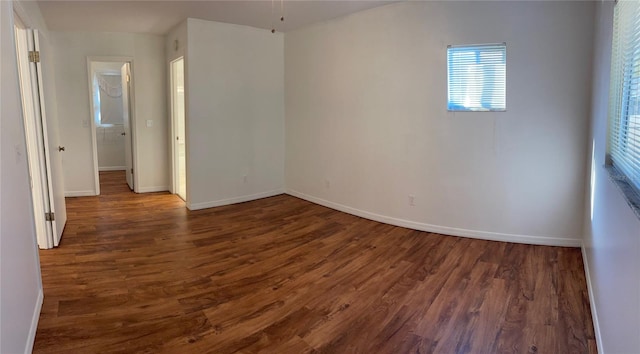 empty room featuring dark hardwood / wood-style flooring