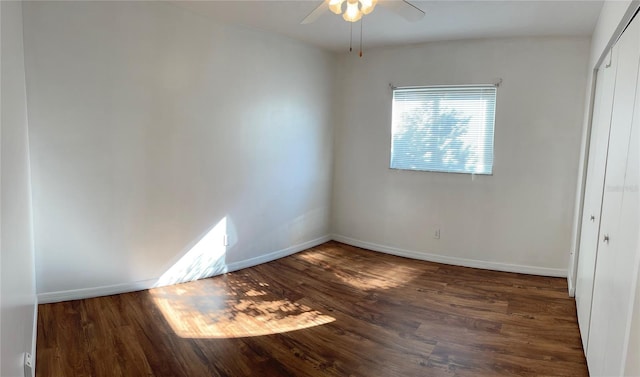 spare room with dark hardwood / wood-style floors and ceiling fan