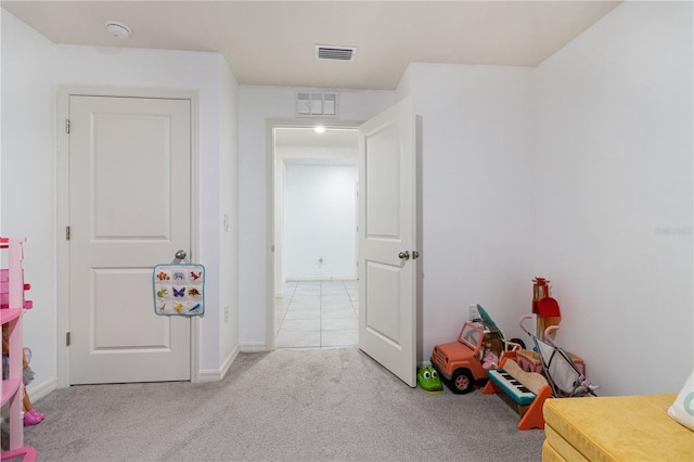 rec room with light colored carpet