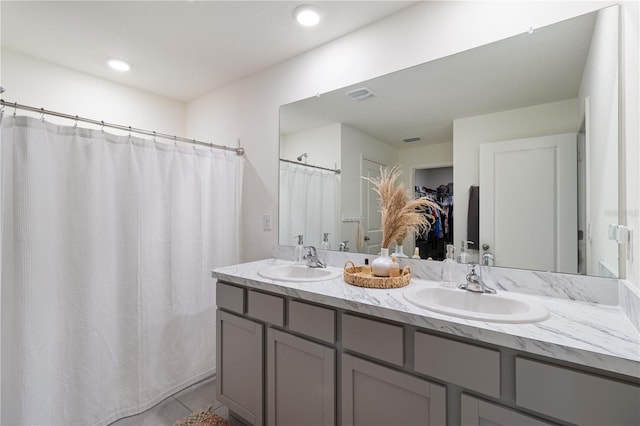 bathroom with tile patterned flooring and vanity