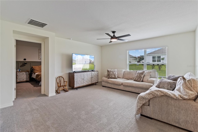 living room featuring carpet flooring and ceiling fan