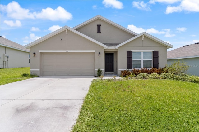 single story home with a garage and a front lawn