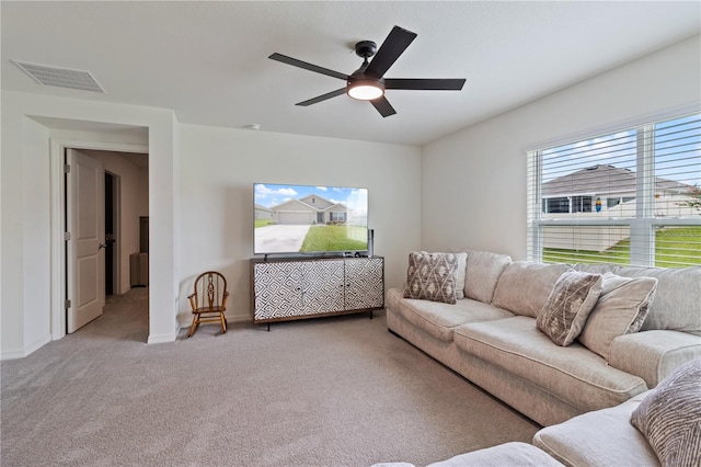 living room featuring carpet and ceiling fan