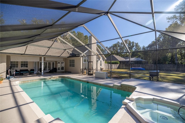 view of swimming pool with an in ground hot tub, french doors, a patio, and a lanai