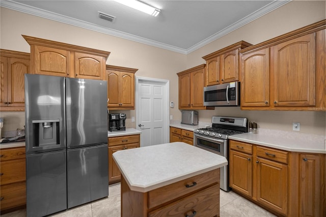 kitchen with light tile patterned floors, a center island, stainless steel appliances, and crown molding