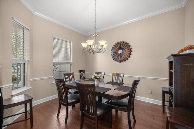 dining space featuring dark wood-type flooring, a chandelier, and ornamental molding