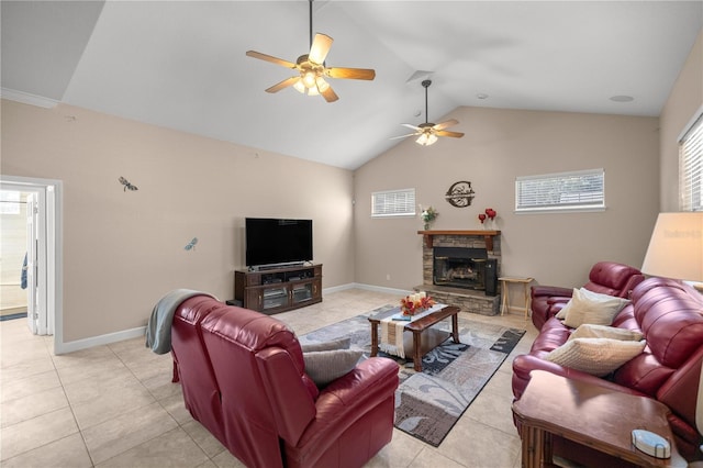 tiled living room featuring ceiling fan, a fireplace, and vaulted ceiling