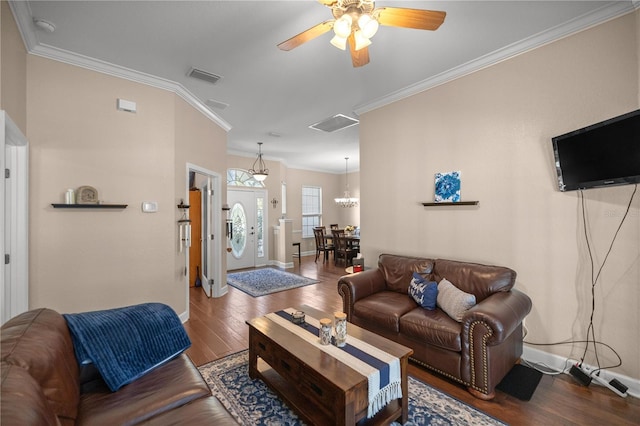 living room featuring wood-type flooring, ceiling fan with notable chandelier, and crown molding