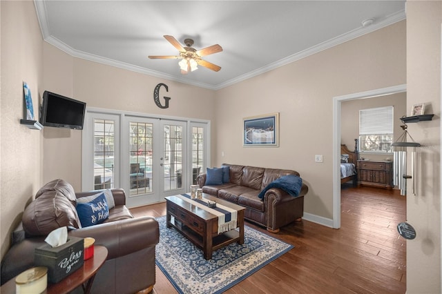 living room with ceiling fan, dark hardwood / wood-style flooring, crown molding, and french doors