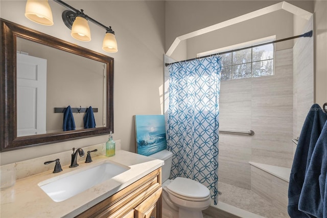 bathroom with curtained shower, vanity, and toilet