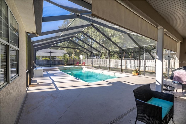 view of swimming pool with a patio area and glass enclosure