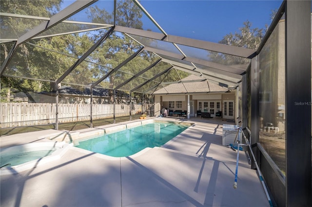 view of swimming pool featuring a patio area, an outdoor living space, and glass enclosure