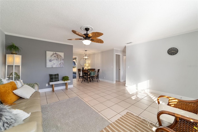 living room with a textured ceiling, ceiling fan, ornamental molding, and light tile patterned flooring